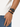 A braided black bracelet worn alongside a sleek black watch on a person's wrist.