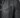 Close-up of a black leather jacket featuring a zippered pocket and ribbed shoulder detailing.
