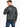 A man in a fitted black leather jacket with ribbed detailing, viewed from the back, paired with blue jeans.