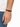 A close-up of a man's wrist wearing a black and brown leather bracelet with a simple clasp.