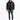 A man stands wearing a black puffer coat, black shirt, distressed jeans, and sneakers against a white background.