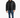 A man stands wearing a black puffer coat, black shirt, distressed jeans, and sneakers against a white background.
