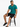 Carbon Classic Tee in turquoise, seated on a stool