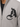 Gray zip-up jacket featuring a textured black logo on the chest, worn over a black shirt.