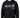 A man wearing a black hoodie with graphic text and a front pocket, paired with blue jeans.