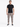 A man stands confidently in a fitted black t-shirt paired with gray cargo pants and stylish sneakers.