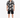 A man stands wearing a short-sleeve button shirt with a black and white graphic print, paired with black shorts.