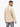 A man with short hair wears a textured beige top, showcasing a subtle geometric pattern from a rear view.