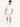 A man walks in a casual outfit featuring light-colored shorts and a plain white t-shirt, paired with white sneakers.