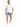 A man stands confidently in a white t-shirt and light blue denim shorts, paired with white sneakers.