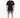 A man stands wearing rolled denim shorts, a black t-shirt with graphic text, and stylish sneakers.