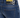 Close-up of denim shorts featuring a black waistband with a logo and a tag displaying care instructions.