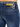 Close-up of denim shorts featuring a black waistband with a logo and a tag displaying care instructions.