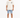A person stands wearing a loose-fitting beige t-shirt and light blue denim shorts, paired with white sneakers.