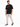 A man stands confidently in a black t-shirt with a motivational quote, paired with light cargo pants and stylish snea...