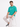 A man sits on a stool wearing a teal t-shirt with a motivational quote, paired with light cargo pants and sneakers.
