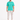 A man stands wearing a turquoise t-shirt with white text, paired with light cargo pants and black sneakers.