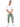 A man stands confidently in a white t-shirt and light green cargo pants, paired with white sneakers.