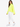 A woman stands in a bright yellow, oversized top paired with white joggers and white sneakers.