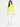 A model wearing a bright neon yellow turtleneck top paired with white jogger pants and white sneakers.