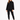 A woman stands confidently in a black, oversized sweatshirt paired with matching joggers and white sneakers.