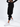 A model wearing black jogger pants paired with white sneakers, showcasing a relaxed fit and elastic cuffs.