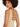 A woman with curly hair poses, showcasing a beige bodysuit with a stylish back design featuring straps.