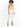 A model poses in a fitted beige bodysuit paired with tailored white pants and black strappy heels.