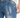 Close-up of denim shorts featuring a distressed design, light blue wash, and classic five-pocket styling.