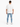 A man stands with his back to the camera, wearing light blue ripped jeans and a loose-fitting white t-shirt.