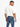 A man wearing a light-colored oversized t-shirt and fitted blue jeans, viewed from the back.