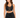 A model poses in a black cropped top with lace-up detailing and a matching skirt featuring side ties.