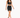 A model walks confidently in a black cropped top and matching skirt with lace-up details and a bow tie.