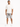 A man stands confidently in a casual outfit featuring distressed gray shorts and a loose-fitting white t-shirt.