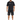 A man stands wearing a black graphic t-shirt and distressed black shorts, paired with black sneakers.