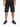 Black denim shorts with distressed detailing, worn with a black t-shirt and athletic sneakers.