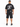 A person wearing a black oversized t-shirt with a graphic design on the back and black shorts, standing from behind.