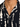 Close-up of a button shirt featuring a black and cream abstract pattern with a classic collar and single button.