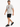 A man walks confidently in a light gray t-shirt with a colorful graphic design, paired with black shorts and sneakers.