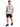 A man stands wearing a light gray t-shirt with colorful graphic designs, paired with black denim shorts and sneakers.