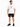 A man stands wearing a white graphic t-shirt, black denim shorts, and black sneakers, posing casually.
