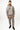 A man stands wearing a gray hoodie and matching joggers with a subtle leaf pattern and black sneakers.