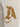 Beige apparel featuring a textured, brown logo design on the thigh, adding a unique visual element.