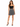 A woman stands confidently in a fitted black top and a flared skirt with a bold monochrome pattern.