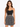 A model poses in a fitted black top and a flared skirt featuring a monochrome animal print design.