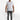 A man stands confidently in a fitted white t-shirt and gray jeans, complemented by white sneakers.