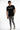 A model wearing a black t-shirt with a graphic design, paired with distressed gray jeans and stylish sneakers.