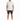 A man stands wearing a short-sleeve, patterned shirt with blue designs, paired with dark denim shorts and white sneak...