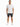 A man stands wearing a short-sleeve, patterned shirt with blue designs, paired with dark denim shorts and white sneak...