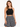A woman models a black crochet halter top paired with a patterned black and white skirt.
